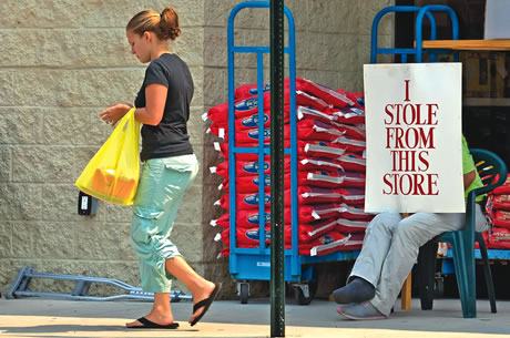 Shoplifter displays sign